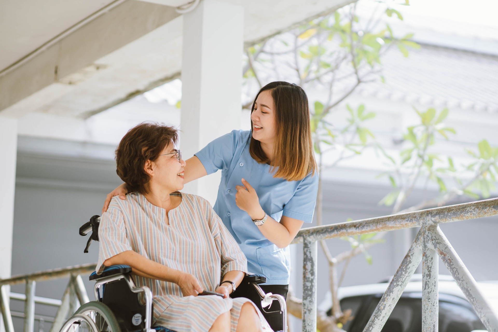 physiotherapist taking care of patient in wheelchair